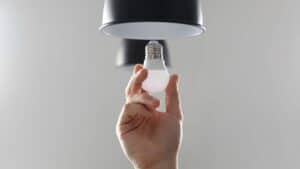 Man plugging in a light bulb
